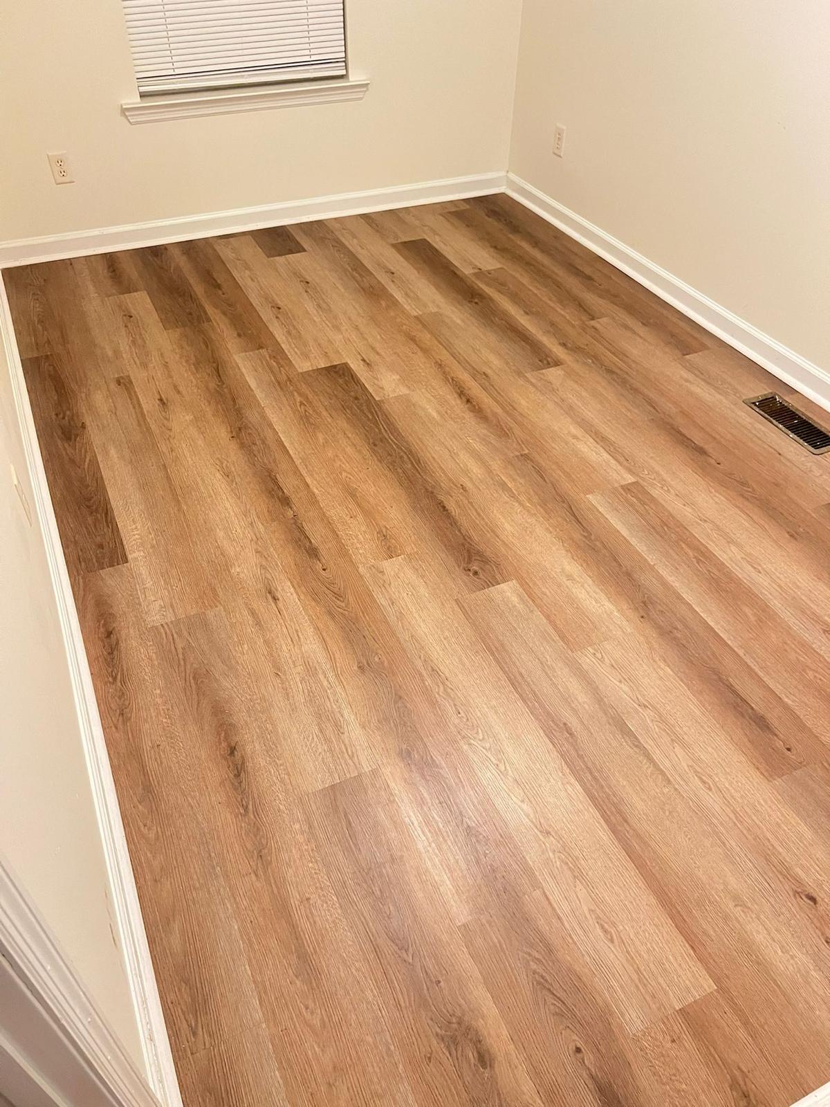 Bedroom with warm-tone LVP vinyl flooring