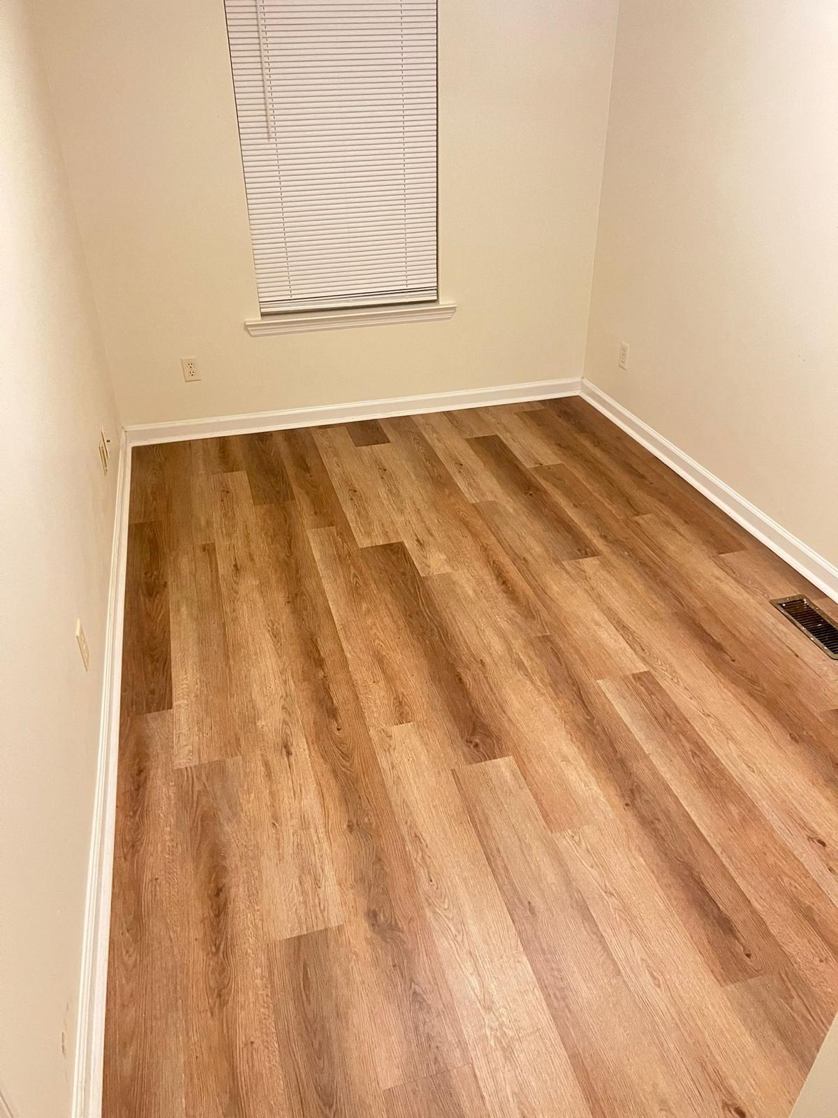 Finished room with oak-tone LVP vinyl flooring