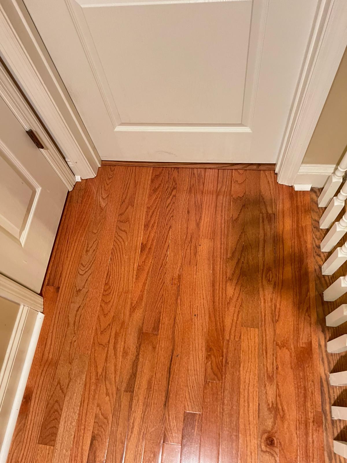 Solid oak floor next to a stair railing